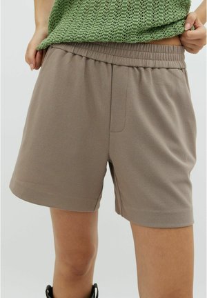 Bruna shorts med elastiskt midjeband, som har en mjuk textur och en framficka. Designen är avslappnad och slutar vid mitten av låret.
