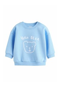 Svijetloplavi dukserica s okruglim izrezom, rebrastim manžetama i tekstom "Hello BEAR". Ima izvezeno lice medvjeda u bijeloj boji.