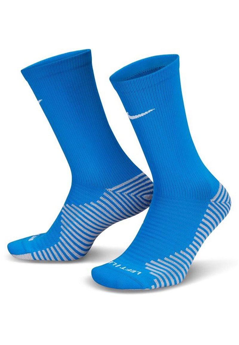 Modre športne nogavice z rebrastim dizajnom, opremljene z belim logotipom Nike in teksturiranim črtastim vzorcem na podplatih za oprijem in podporo.