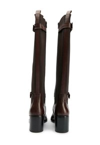 Brown leather knee-high boots with a textured fabric panel, side zippers, and chunky heels. Features accent straps at the top.