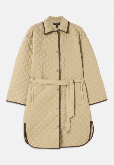 Quilted beige coat with a collar, featuring brown trim, snap buttons, side pockets, and a matching belt. Textured diamond pattern throughout.