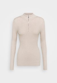 Pull à col roulé côtelé beige avec manches longues et fermeture à demi-fermeture éclair. Texture douce et coupe ajustée qui accentuent la silhouette.