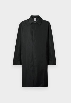 Black long coat with a classic collar, single visible button at the neck, side pockets, and concealed front closure.