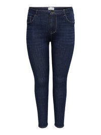 Tummansiniset, kapealahkeiset farkut, joissa viisi taskua ja nappikiinnitys, valkoista taustaa vasten esillä.