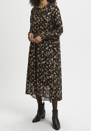 Robe noire à fleurs avec manches longues, col rond et jupe à volants. Fabriquée en tissu léger et transparent avec des accents dorés.