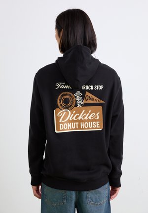 Black hoodie featuring a rear graphic print with a donut illustration, "Dickies Donut House," and other text in beige and white.