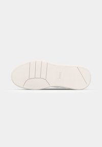 Shoe sole in white rubber with textured pattern, featuring grooves and a rounded heel. "BOSS" logo embossed near the toe area.