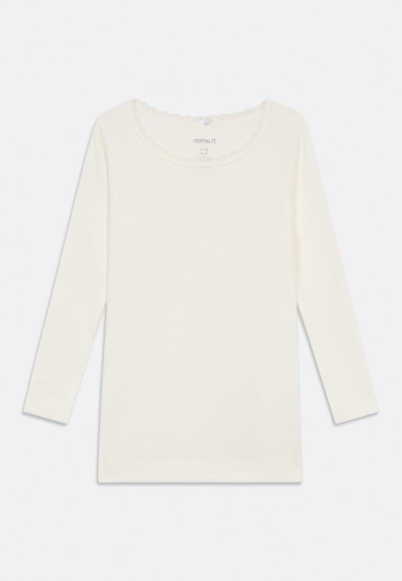 Langärmliges cremefarbenes Hemd aus weicher Baumwolle mit einem gewellten Halsausschnitt und gerippter Textur. Schlichtes, klassisches Design ohne Muster.