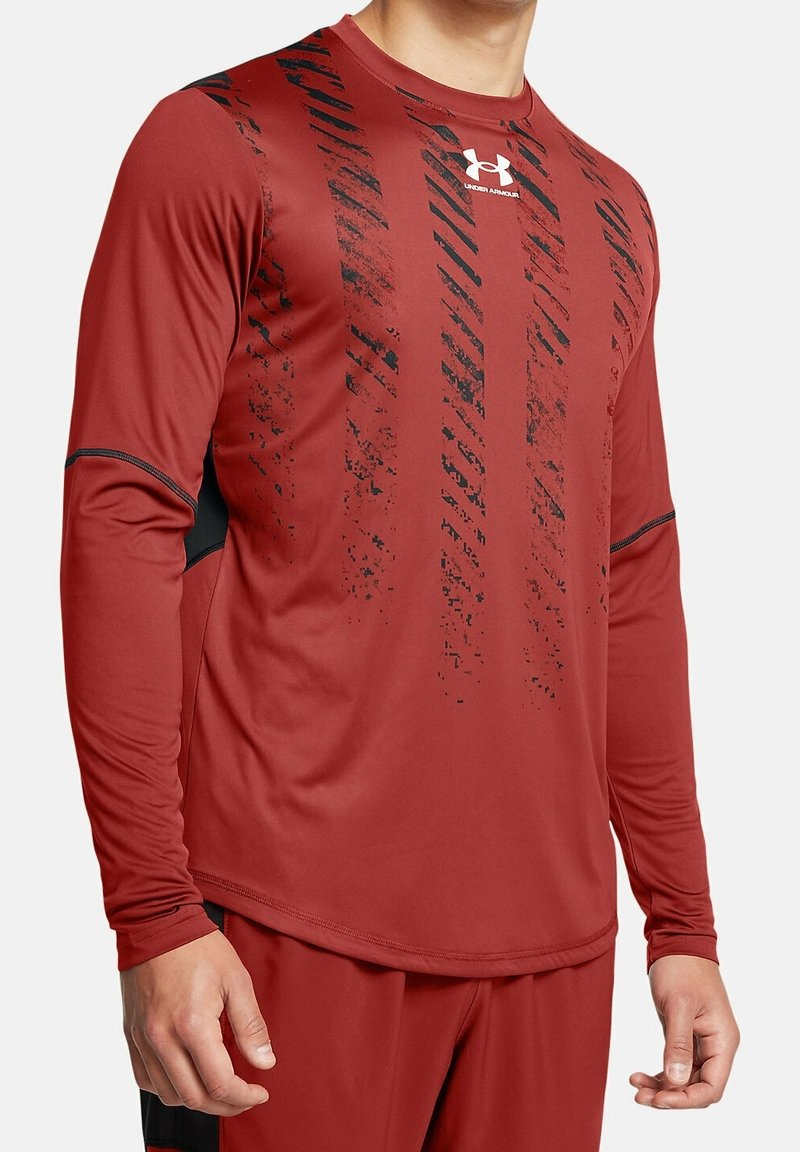 Rotes langärmeliges Sportshirt aus synthetischem Material, mit schwarzen diagonalen Streifen und einem Logo auf der oberen linken Brust.