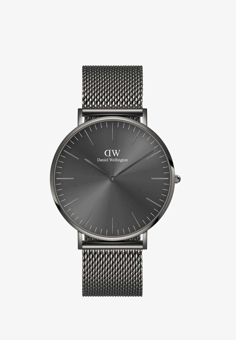 Ümar must kell halli dialsiga, minimaalsete tundide märkidega ja hõbedase tooniga käepidemetega. Varustatud on kootud roostevabast terasest võrksangaga.