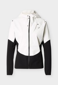 Λευκό και μαύρο μπουφάν με φερμουάρ και κουκούλα, μακριά μανίκια και μικρό λογότυπο στην αριστερή πλευρά του στήθους.