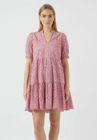 Pink cotton dress with embroidered eyelet details, short puff sleeves, a V-neck, and a tiered skirt ending above the knee.