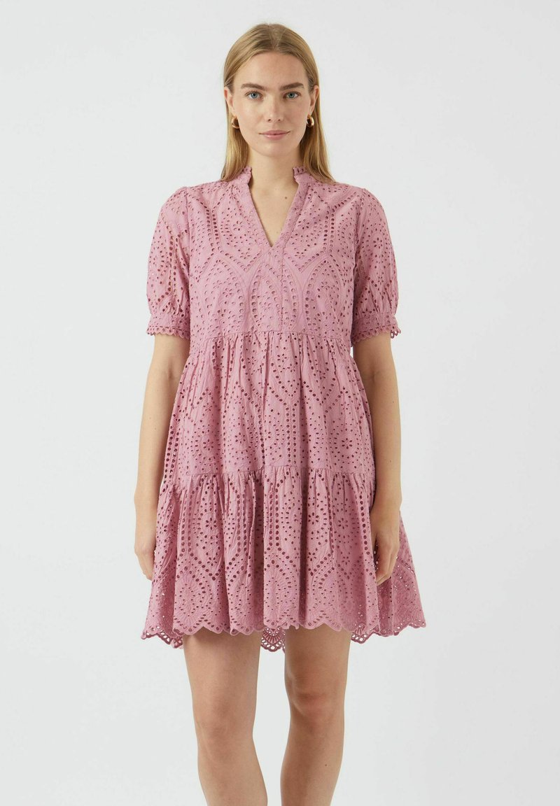 Pink cotton dress with embroidered eyelet details, short puff sleeves, a V-neck, and a tiered skirt ending above the knee.