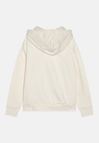 Sweatshirt à capuche couleur crème vu de dos avec des manches longues et des poignets et un ourlet côtelés.