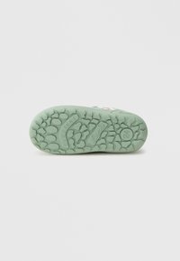 Rubber shoe sole with a textured grip pattern. Light green color, featuring embossed branding and raised accents.