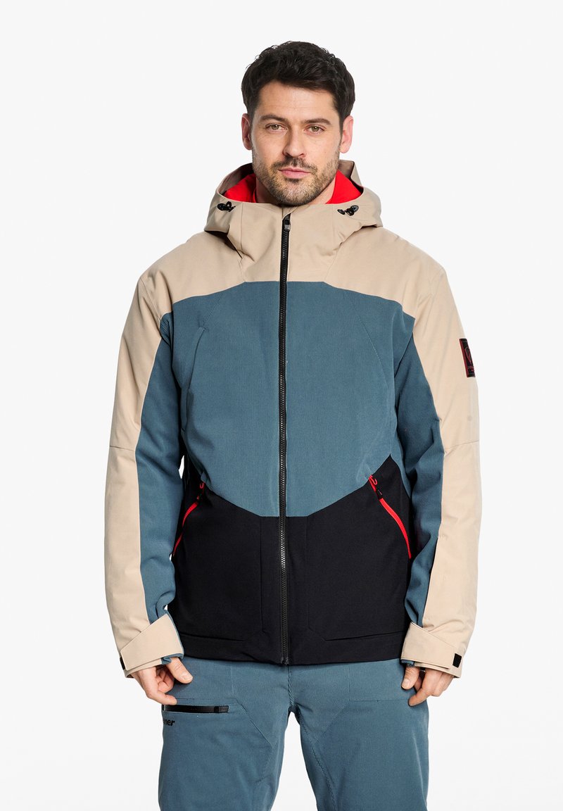 Männer Steppjacke in Beige, Petrol und Schwarz. Mit Kapuze, kontrastierenden Schulterpaneelen, Reißverschlusstaschen und roten Akzenten.