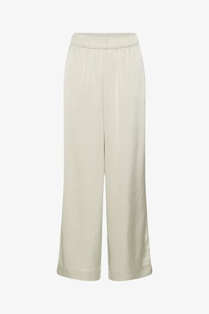 Hellbeige, weit geschnittene Hose mit elastischem Bund und glattem Stoff, lockere Passform, ohne sichtbare Taschen oder Verzierungen.