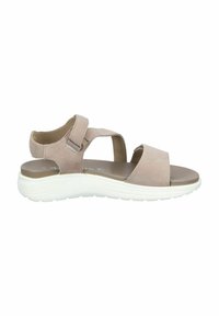 Beige suede sandal with dual straps, adjustable buckle, and a white cushioned sole. Features a flat design for comfort and stability.