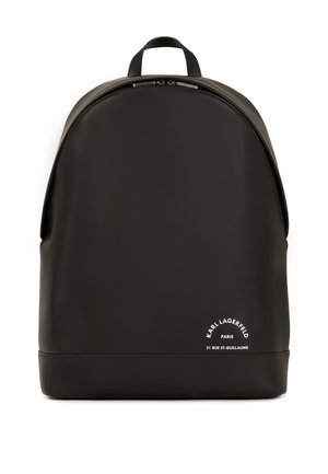 Black backpack made of smooth, durable material with a rounded top, zip closure, and white branding detail on the bottom.