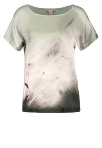 Light gray short-sleeve blouse with a soft, blurred dandelion seed print extending from the bottom hem to the chest.