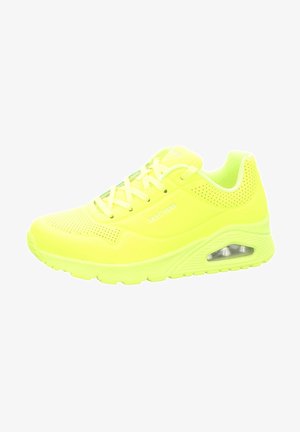 Neon yellow sneaker with a mesh upper, padded tongue and collar, logo detail, and air cushioning in the sole. Perforated accents throughout.
