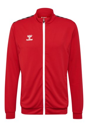 Czerwona kurtka zapinana na zamek z fakturowanej tkaniny z białym zamkiem, z logo na klatce piersiowej i czarnymi akcentami wzoru na ramionach.