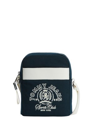 Granatowa torba na ramię Tommy Jeans z białym poziomym paskiem, wyszywanym logo i regulowanym białym paskiem.