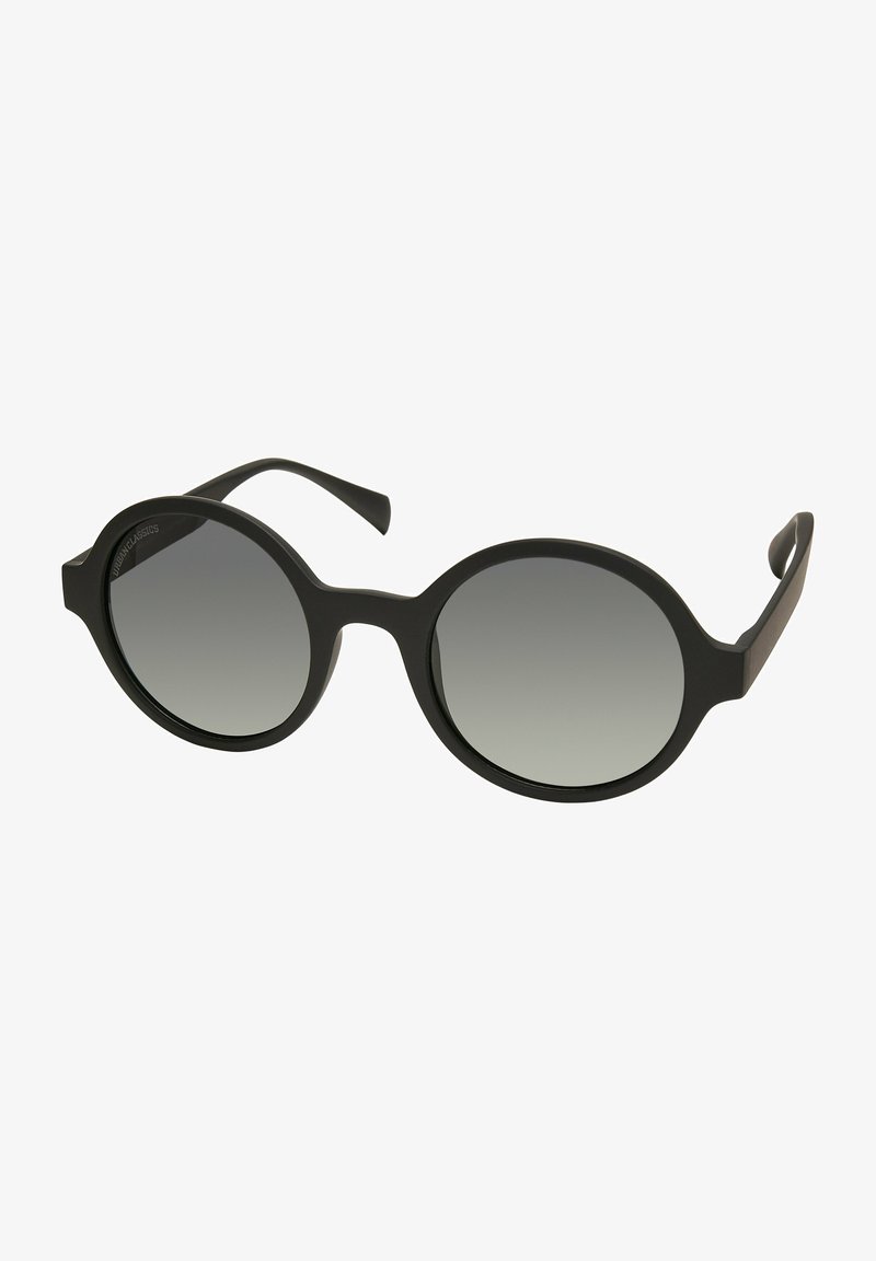 Mustad mustad prillid ümmarguste gradueeritud läätsedega. Omab mattpinda, kaardus servi ja peeneid piirdeid, mis annavad stiilse välimuse.