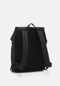 Black backpack with a textured, mesh back panel and smooth material. Features adjustable straps and a top carry handle.