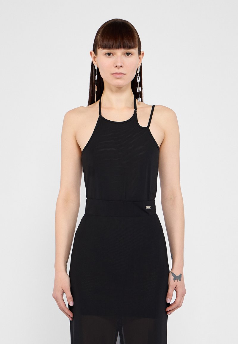Black halter dress with sheer fabric, fitted bodice, and flowing skirt. Features thin straps and a small metallic accent at the waist.