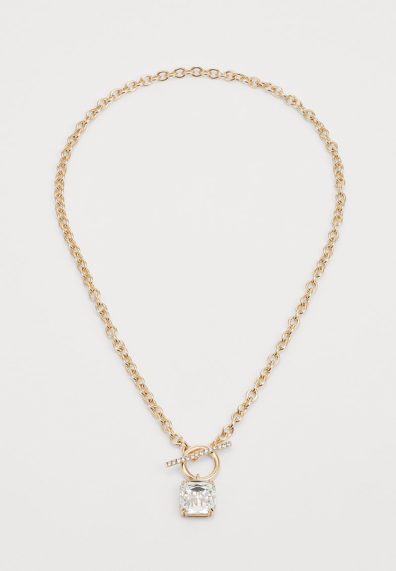 Un collier en chaîne dorée avec un pendentif carré orné d'une pierre précieuse transparente et d'une boucle décorative avec une petite barre accentuée.