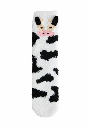 White fluffy sock with black cow spots, featuring a cow face with ears and pink nose embroidered near the top. Soft texture throughout.
