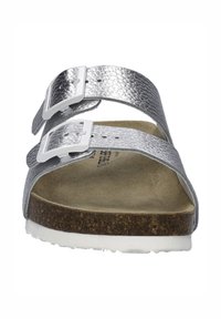 Silver leather sandals with two adjustable straps, white buckles, a cork footbed, and a textured surface. The sole is white, flat, and supportive.