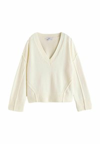 V-hals, cropped sweater i blød creme med ribbede manchetter og kant. Strikket tekstur med en afslappet pasform og sidedejlige detaljer.