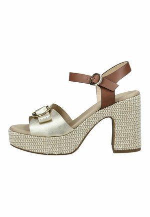 Sandalia de tacón alto grueso con plataforma tejida, tira frontal metálica dorada con hebilla y correa marrón para el tobillo con cierre de hebilla.