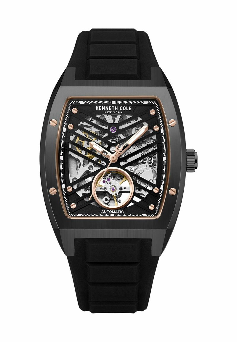 Schwarze automatische Uhr mit einem Skelettzifferblatt, versehen mit roségoldenen Akzenten, einem quadratischen Gehäuse und einem strukturierten schwarzen Gummiband.