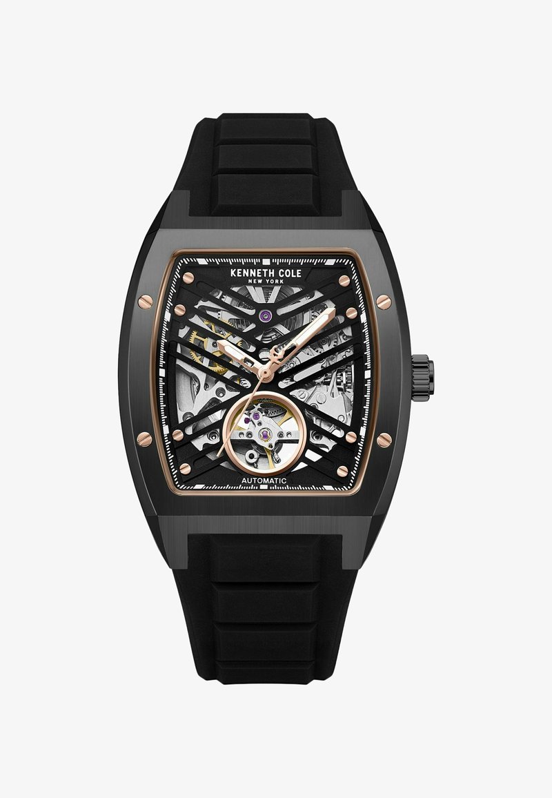 Schwarze automatische Uhr mit einem Skelettzifferblatt, versehen mit roségoldenen Akzenten, einem quadratischen Gehäuse und einem strukturierten schwarzen Gummiband.