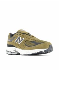 Olive green sneaker with suede and mesh materials, featuring a white midsole, black accents, and a prominent "N" logo on the side.