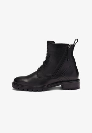 Black leather ankle boot with side zipper, front laces, pull tab, and thick rubber sole with tread for grip.