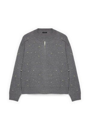Cardígan gris de punto con cierre de cremallera, adornado con detalles texturizados de lunares. Bajo y puños acanalados para mayor detalle.
