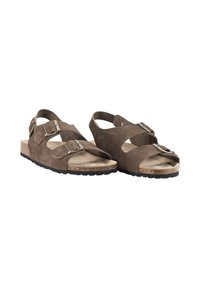 Sandalias de ante marrón con dobles correas cruzadas, hebillas ajustables y una plantilla de corcho texturizado. Suela de goma que ofrece tracción.