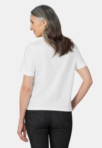 Weißes T-Shirt mit kurzen Ärmeln aus Baumwollstoff, mit Rundhalsausschnitt und lockerer Passform. Die Rückansicht zeigt eine glatte Textur und klare Linien.