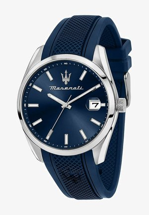 Marineblaue Armbanduhr mit strukturiertem Gummiband, silbernem Edelstahlgehäuse und passendem blauen Zifferblatt mit silbernen Stundenmarkierungen und Datumsfenster.