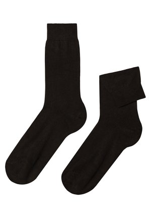 Sorte strømper lavet af et glat, elastisk materiale. De har en standard crew-længde med en forstærket tå og en udtalt ribbet skrål.