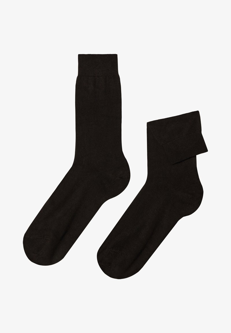 Sorte strømper lavet af et glat, elastisk materiale. De har en standard crew-længde med en forstærket tå og en udtalt ribbet skrål.