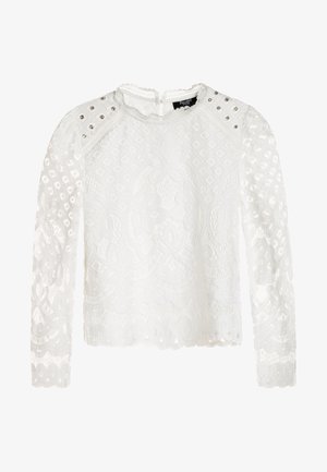Biała bluzka z koronką na długie rękawy, złożona z misternych kwiatowych wzorów, z falistym dołem i srebrnymi ćwiekami na ramionach. Otwarty tył z zapięciem na klucz.