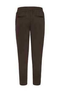 Hnědé kalhoty s elastickým pasem a úzkým střihem. Mají dvě zadní kapsy a hladkou texturu. Bez viditelných log nebo vzorů.