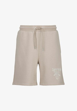 Beige cotton shorts with an elastic waistband and drawstring. Features a white logo print on the left thigh. Smooth texture, above-knee length.
