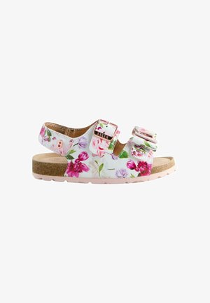 Blumenmuster-Sandalen mit einem weißen und pinken Grund, verstellbaren Riemen, Metall-Schnallen und einem Korkfußbett. Strukturiertes Gummisohle für mehr Halt.