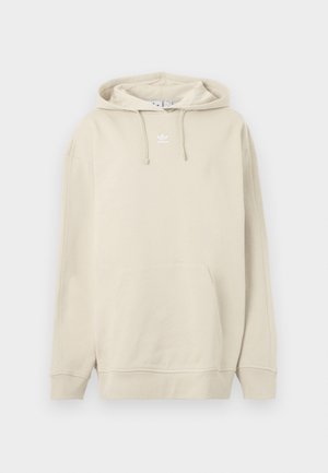 Beige väriinen puuvillainen hupullinen collegepaita, jossa etutasku, resorireunaiset hihansuut ja pieni valkoinen logo rinnassa. Pehmeä pinta.